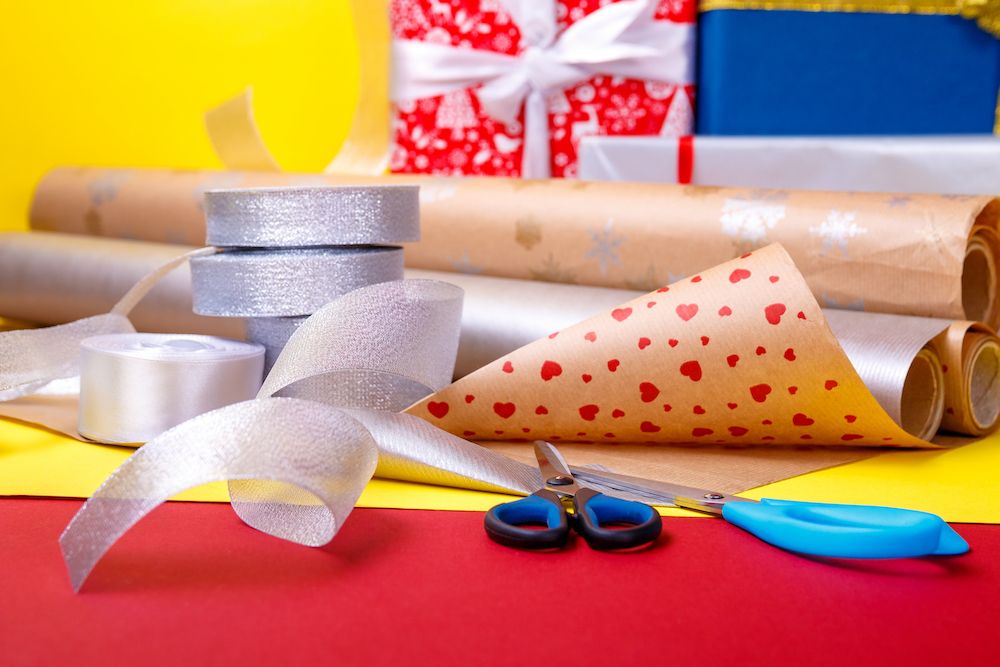 Gift wrapping, boxes, paper, ribbon and scissors on color background. Materials and accessories for wrapping presents.